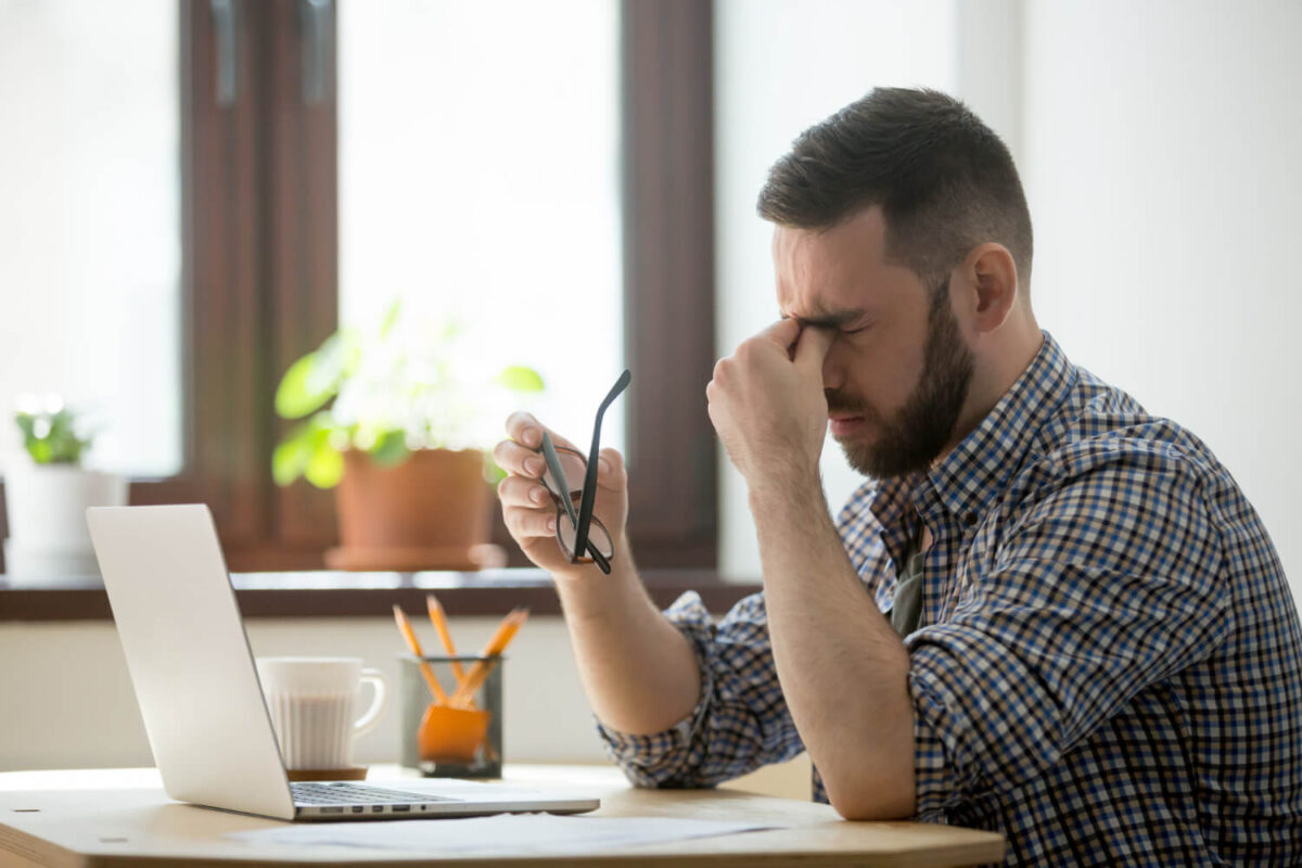 stressed-male-massaging-nose-bridge-suffering-from-headache-1200x800.jpg